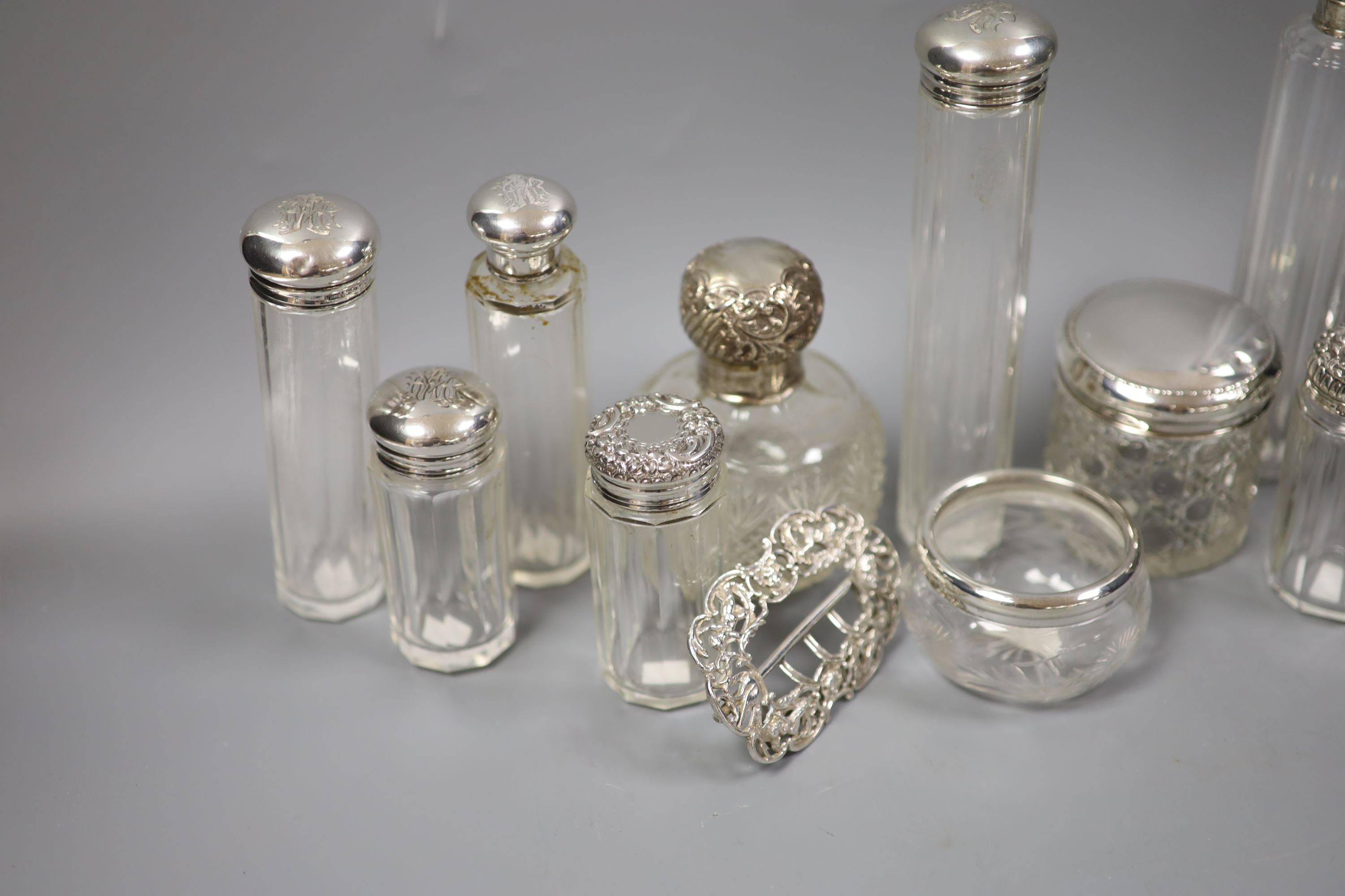 Assorted silver mounted toilet jars and a late Victorian silver belt buckle, London, 1897.